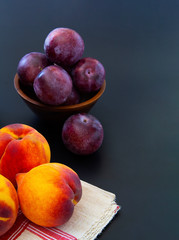 Table filled with delicious peaches and plums.  Healhty snacks.