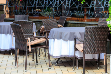 Chairs and tables in cozy outdoor cafe at summer