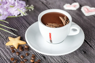 cup of coffee and beans on wooden table
