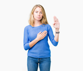 Beautiful young woman wearing blue sweater over isolated background Swearing with hand on chest and open palm, making a loyalty promise oath