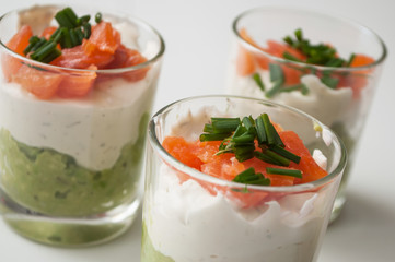 closeup of appetizers in little glasses on white background