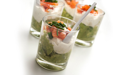 closeup of appetizers in little glasses on white background
