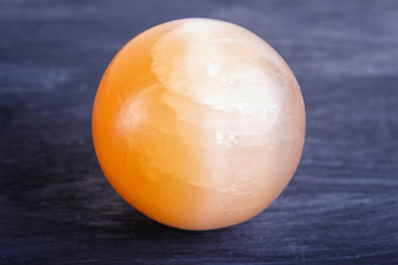 orange onyx sphere on a black background