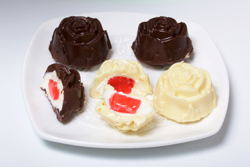 Homemade cheese curds. Some are cut in two, jelly filling is visible.