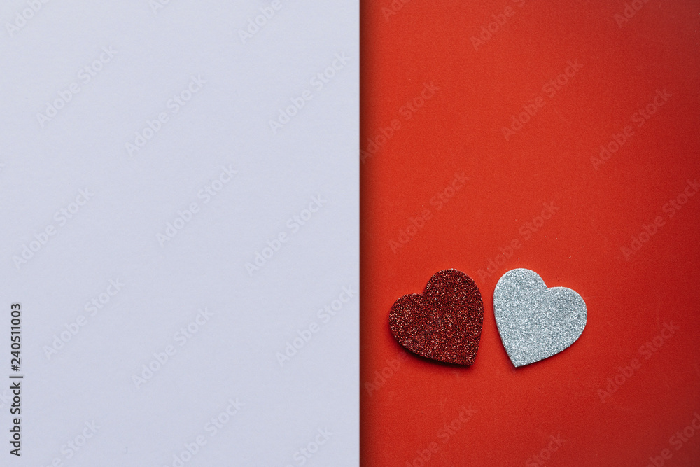 Wall mural two hearts on a red background and next to a place for text or empty space on a white background. va