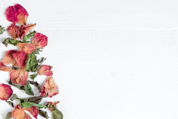 Background with dried leaves and rose petals. Concept with dried rose petals. Photo above. Frame for greeting card with dried rose petals and leaves. Frame for the banner on the site with flowers