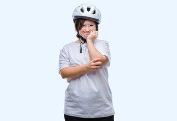 Young adult cyclist woman with down syndrome wearing safety helmet over isolated background looking stressed and nervous with hands on mouth biting nails. Anxiety problem.