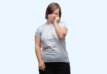 Young adult woman with down syndrome over isolated background looking stressed and nervous with hands on mouth biting nails. Anxiety problem.