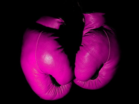 Old Leather Purple Boxing Gloves Hanging In The Dark