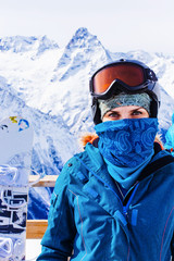 Fototapeta na wymiar Woman with ski mask on a background of mountains.