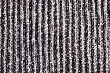 Fragment of creative striped black and white fabric as a background texture.