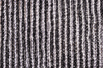 Fragment of creative striped black and white fabric as a background texture.
