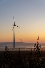 Obraz premium Wind turbines in the morning, partially covered by mist