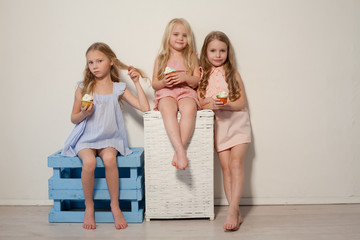 three girlfriends sisters eat sweet lollipop candy