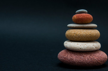 Fototapeta na wymiar pyramid of colored stones in balance