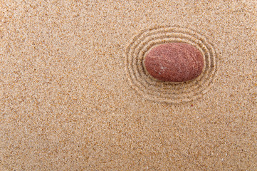Fototapeta na wymiar red stone on the sand in a circle