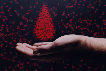 Human hand holding blood drop. Mixed media.