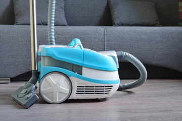 Fototapeta na wymiar Multifunctional vacuum cleaner on the laminate floor