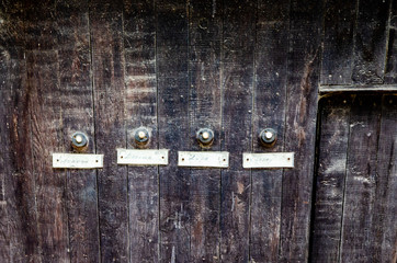 doorbells on an aged wooden wall, Havana, Cuba