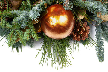 Christmas ball golden color with fir and pine branches on a white background