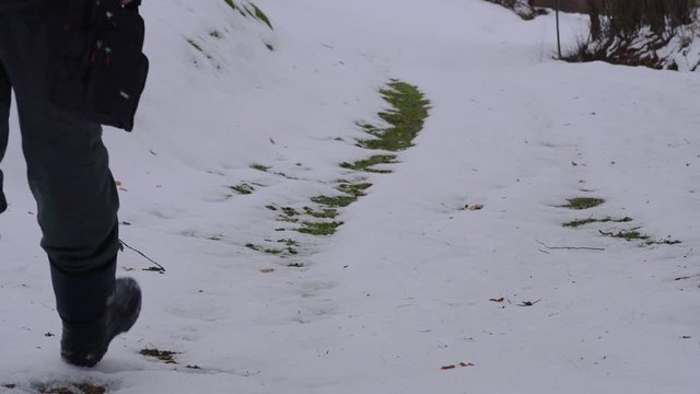 Man goes through snowy forest path - (4K)	