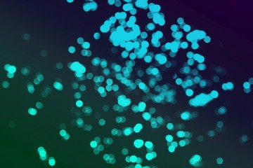 light blue bokeh effect of glossy sparks on black texture - beautiful abstract photo background