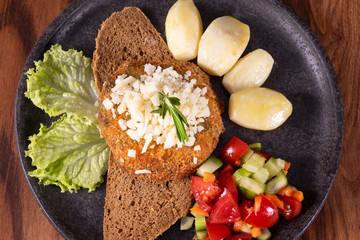Vegan baked sweet potato meatballs, guacamole and vegetables salad. Wooden background, healthy vegetarian food concept
