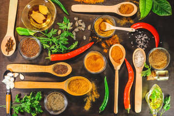 Bitter peppers and spices. lemongrass leaves, kari, chilli, dry spices, flax seeds, pumpkin seeds. on a wooden background.