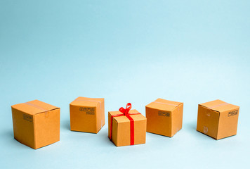 Fototapeta premium A gift box lies among other boxes. The concept of selling goods and services, buying gifts for birthday and new year, Christmas. The right choice of gift, advertising products and services, marketing