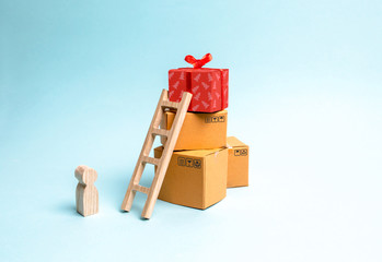 Child stands near a gift box on a pile of boxes. The concept of finding the perfect gift. Limited...