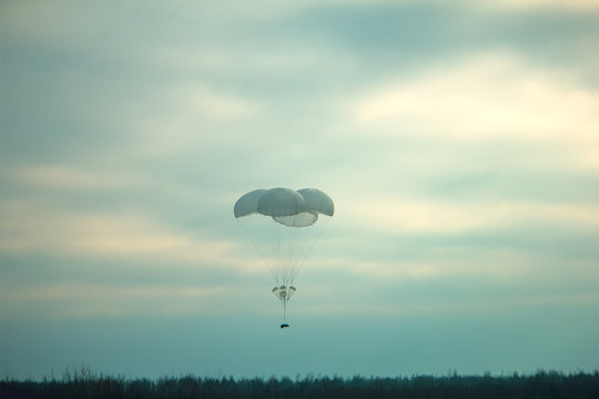 Supply Box Dropped With Parashute At Military Field