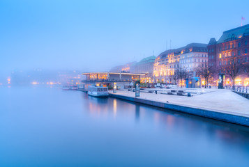The lake Inner Alster (German: Binnenalster) and downtown in Hamburg, Germany, in the fog.
