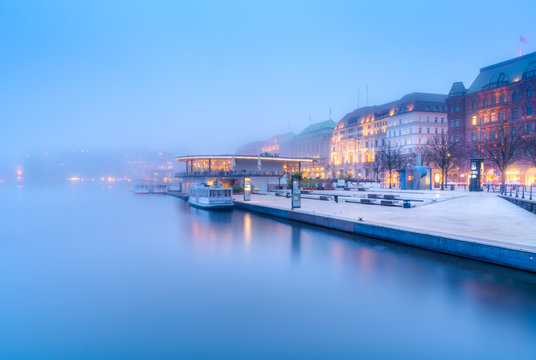 The lake Inner Alster (German: Binnenalster) and downtown in Hamburg, Germany, in the fog.