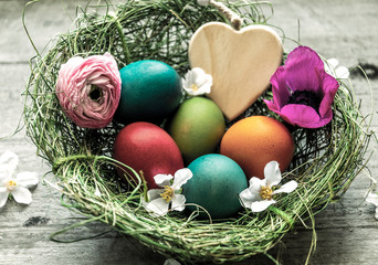 Frohe Ostern, Osternest mit bunten Ostereiern und Herz - Happy Easter,  Easter nest with colorful Easter eggs and heart