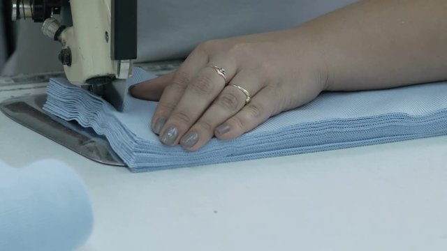 Cutting the fabric, sewing work. Cutting room, cutting blue cloth tailoring knife.