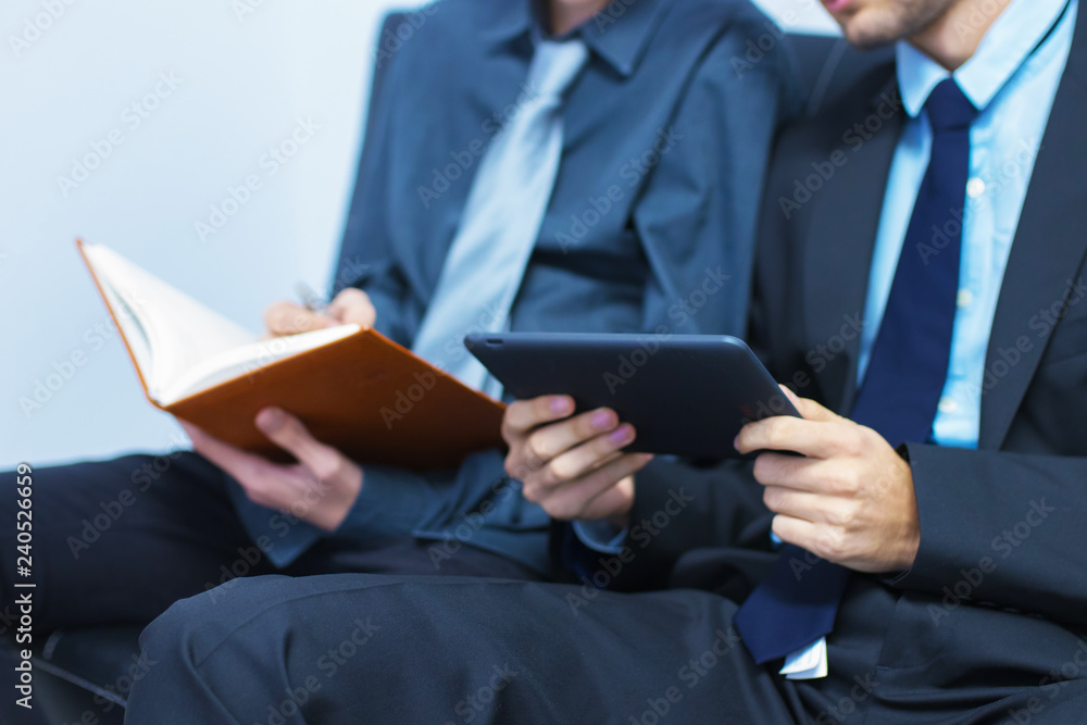 Wall mural business man with tablet or laptop and book