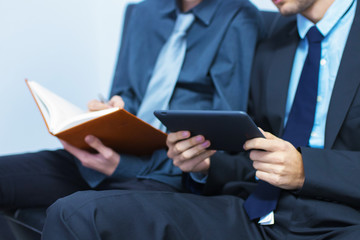business man with tablet or laptop and book