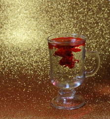 A red drop spreading like a smoke in a cup, seems blood, poison, something magical