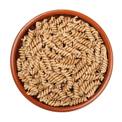 wholemeal pasta fusilli in clay pot isolated  on white, top view - Image