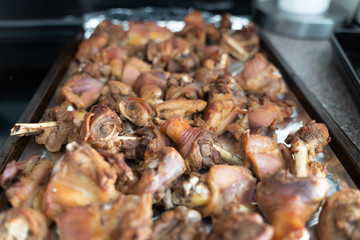 Pieces of freshly roasted chicken in tray
