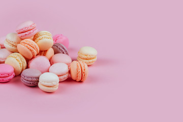 Sweet french macarons on pink background.