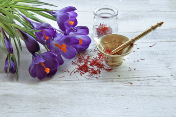 Saffron with crocus flowers on table 