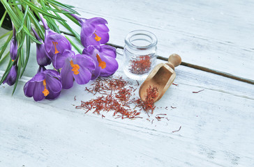 Saffron with crocus flowers on table 