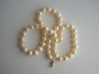 Pearl necklace on paper