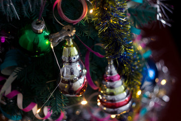 Retro Christmas tree toy in the form of snowman on a background garlands