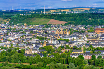 Fototapeta premium Aerial view of Trier, Germany, on a sunny summer day. Trier lies in a valley between vine-covered hills in the west of the state of Rhineland-Palatinate and within the Moselle wine region.