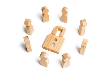 Wooden figures of people surround the padlock. concept of protection of personal data trade secrets, Preservation of secrets. Bank secrecy. Protection of information networks, dedication to secrets.