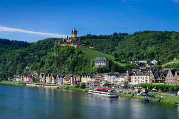 Fototapeta premium The town of Cochem, Germany, in the summer. It lies in the most romantic part of the Moselle Valley, where the river curves between two hiking paradises - Eifel and Hunsrück.