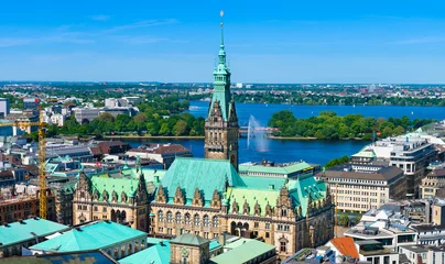 Aerial view of downtown Hamburg, Germany, on a sunny day. The city hall (German: Rathaus) is the most prominent building with the lake Alster in the background. © foto-select