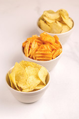 Three sorts of crispy and corrugated potato chips